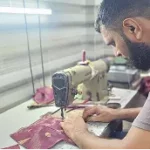 sustainable fashion collection display with handcrafted textiles, boutique setting